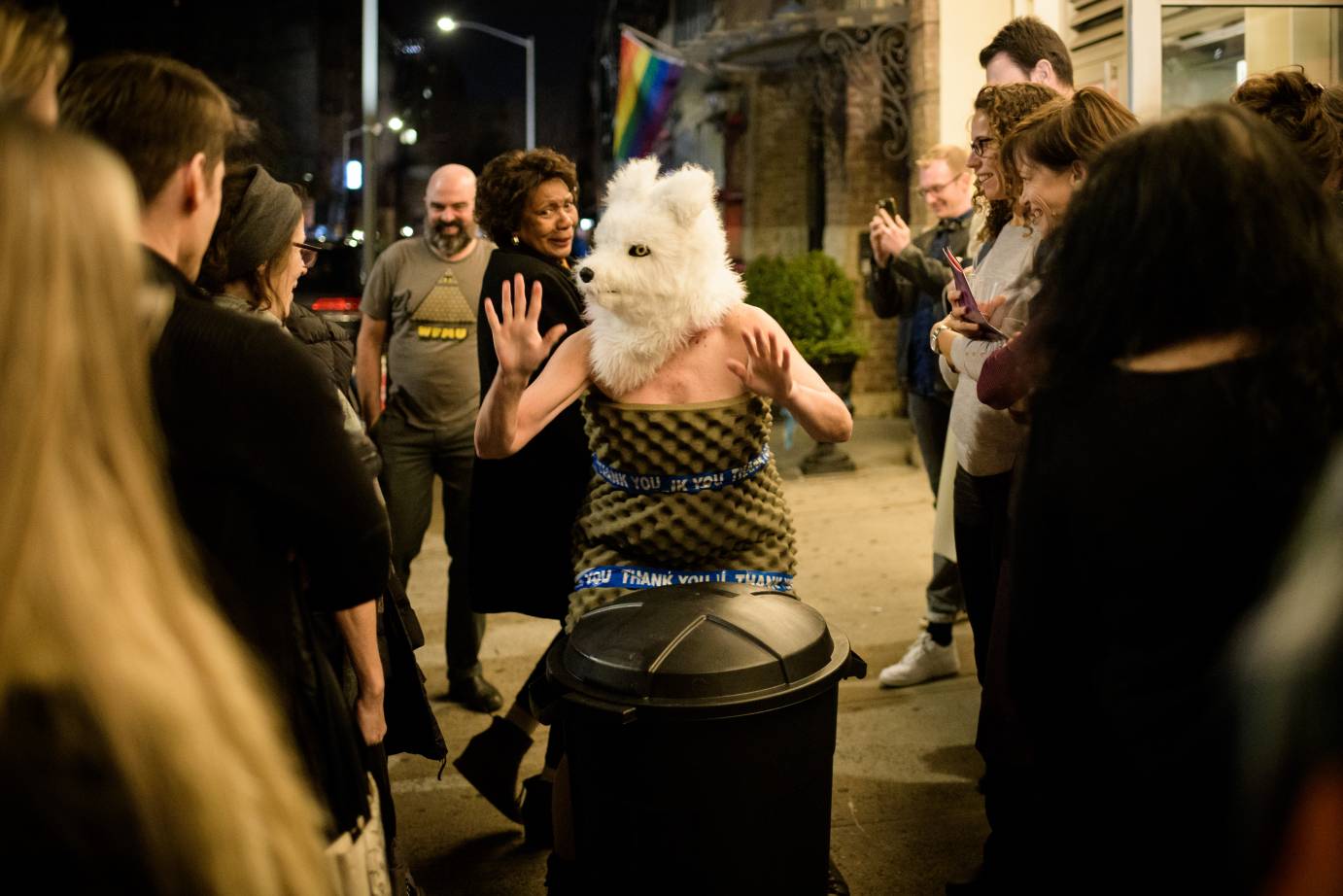 Woman in wolf head surprises crowd outside theater